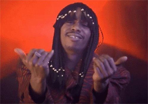 A Woman With Braids Is Smiling With Her Hands Outstretched GIF