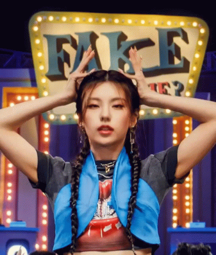 A Woman With Braids Is Standing In Front Of A Sign That Says Fake GIF