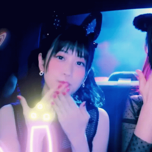 A Woman With Bunny Ears On Her Head Is Making A Funny Face GIF