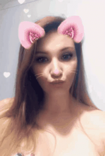 A Woman With Cat Ears On Her Head Making A Funny Face GIF