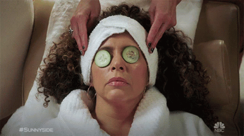 A Woman With Cucumber Slices On Her Eyes Is Getting A Massage From Sunnyside GIF