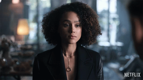 A Woman With Curly Hair And A Netflix Logo On The Bottom GIF