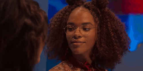 A Woman With Curly Hair And Glasses Says I 'M Speaking Into The Universe GIF