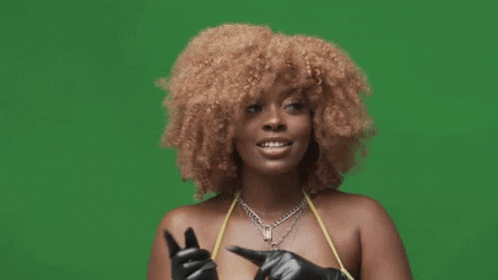 A Woman With Curly Hair And Gloves Is Giving A Thumbs Up Sign . GIF