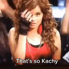 A Woman With Curly Hair Covering Her Face With Her Hand And The Words That 'S So Kachy Below Her GIF