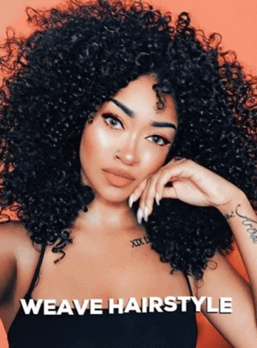 A Woman With Curly Hair Has A Tattoo On Her Wrist That Says Xix GIF