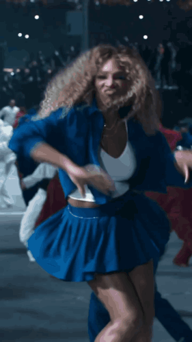Woman With Curly Hair Dancing In Blue GIF