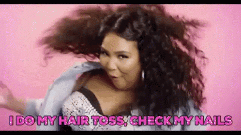 A Woman With Curly Hair Is Dancing On A Pink Background . GIF
