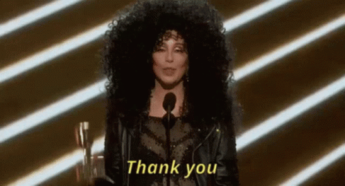 A Woman With Curly Hair Is Giving A Speech And Says Thank You . GIF