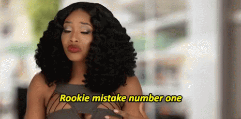 A Woman With Curly Hair Is Making A Funny Face And Says `` Rookie Mistake Number One '' . GIF