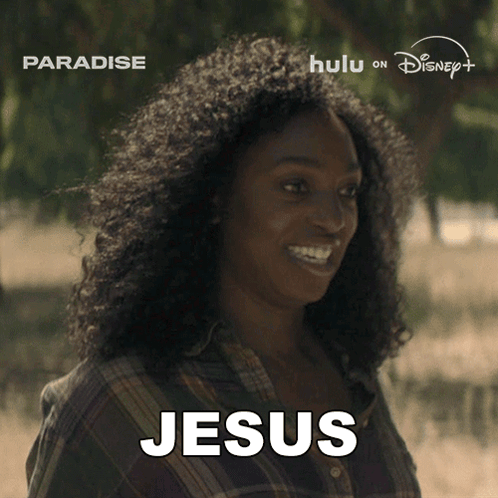 a woman with curly hair is smiling and the word jesus is on her face