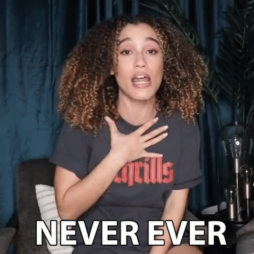 A Woman With Curly Hair Is Wearing A T-Shirt That Says Never Ever GIF