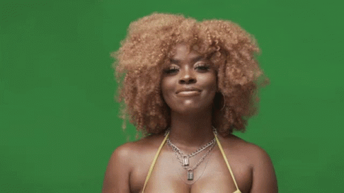 A Woman With Curly Hair Is Wearing A Yellow Bikini And A Black Glove . GIF
