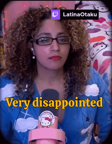 a woman with curly hair is wearing glasses and a hello kitty sweater