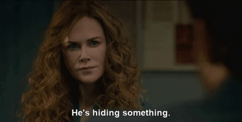 A Woman With Curly Hair Says He 'S Hiding Something In Front Of A Man GIF
