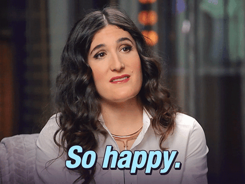 A Woman With Curly Hair Says So Happy In Blue Letters GIF