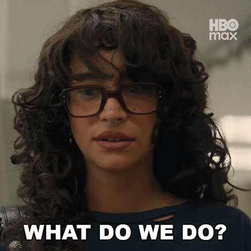A Woman With Curly Hair Wearing Glasses Says What Do We Do GIF