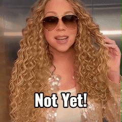 A Woman With Curly Hair Wearing Sunglasses And A Caption That Says Not Yet GIF