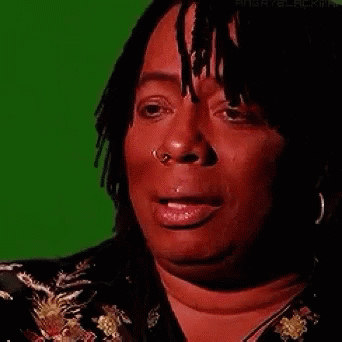 A Woman With Dreadlocks And A Nose Ring Is Crying . GIF