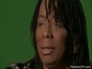 A Woman With Dreadlocks And A Nose Ring Is Making A Funny Face . GIF
