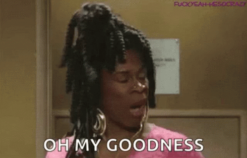 A Woman With Dreadlocks And Earrings Is Standing In A Doorway And Saying `` Oh My Goodness '' . GIF