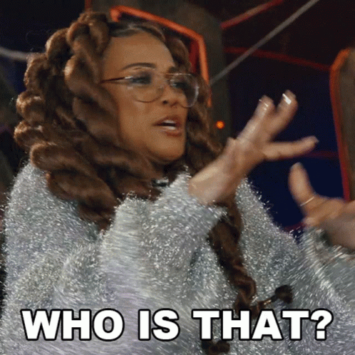A Woman With Dreadlocks And Glasses Says " Who Is That " GIF