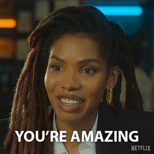 A Woman With Dreadlocks Is Smiling And Says You 'Re Amazing On The Bottom GIF