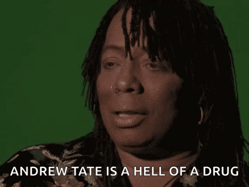 A Woman With Dreadlocks Is Talking About Andrew Tate GIF