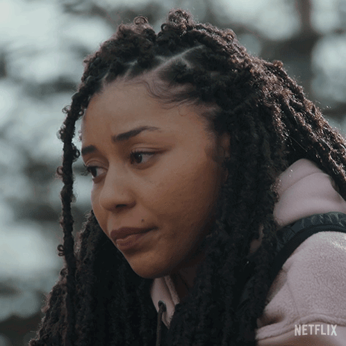 A Woman With Dreadlocks Is Wearing A Pink Netflix Hoodie GIF