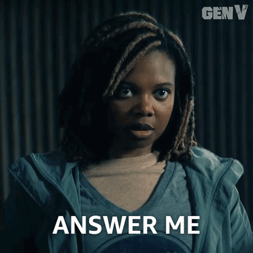 A Woman With Dreadlocks Says Answer Me In Front Of A Genv Logo GIF