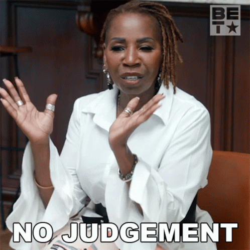 A Woman With Dreadlocks Says No Judgement With Her Hands Up GIF