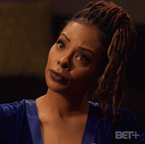 A Woman With Dreadlocks Says " Who Is That " In Front Of A Bet Logo GIF