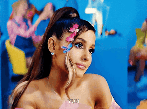 A Woman With Flowers In Her Hair Says Yuh On The Bottom GIF