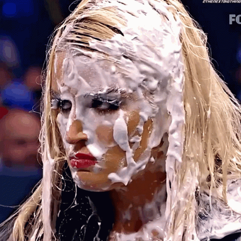 A Woman With Foam On Her Face Has The Letters Fc On The Bottom GIF
