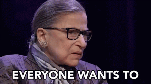 A Woman With Glasses And A Scarf Is Saying Everyone Wants To GIF