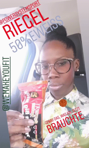 A Woman With Glasses Is Holding A Bag Of Riegel 50 % Eweiss GIF