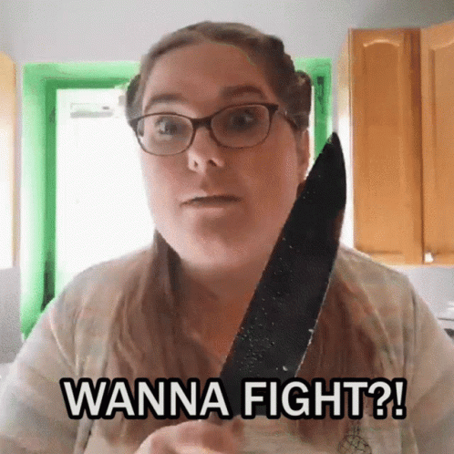 A Woman With Glasses Is Holding A Knife And Saying Wanna Fight GIF