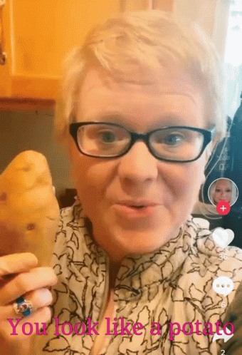 A Woman With Glasses Is Holding A Potato With The Words " You Look Like A Potato " Above Her GIF