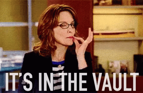 A Woman With Glasses Is Smoking A Cigarette And The Words It 'S In The Vault Are Behind Her GIF