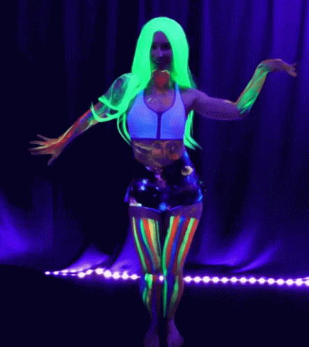 A Woman With Glow In The Dark Paint On Her Body Dancing GIF