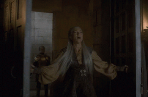 A Woman With Gray Hair Is Standing In A Dark Room GIF