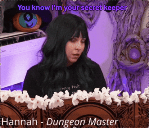 a woman with green hair is standing in front of a sign that says " hannah - dungeon master "
