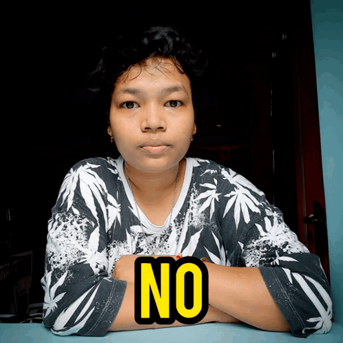 A Woman With Her Arms Crossed And The Word No On Her Chest GIF