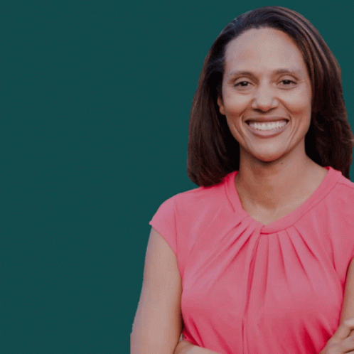 A Woman With Her Arms Crossed Is Smiling In Front Of A Green Background That Says Vote Sydney GIF
