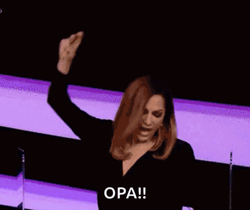 A Woman With Her Arms In The Air And The Word Opa Written On The Bottom GIF