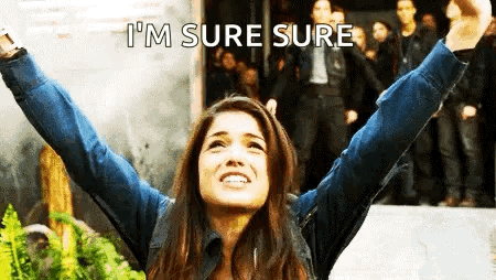 A Woman With Her Arms In The Air And The Words `` I 'M Sure Sure '' Written Above Her . GIF
