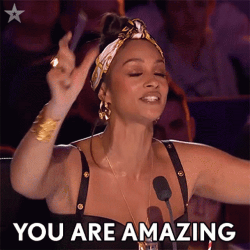 A Woman With Her Arms In The Air And The Words " You Are Amazing " Behind Her GIF