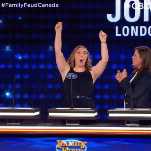 A Woman With Her Arms In The Air On A Family Feud Game Show GIF