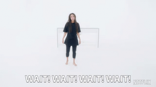 A Woman With Her Arms Outstretched Says Wait Wait Wait Wait Netflix GIF