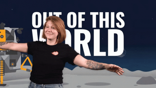 A Woman With Her Arms Outstretched Stands In Front Of A Poster That Says Out Of This World GIF